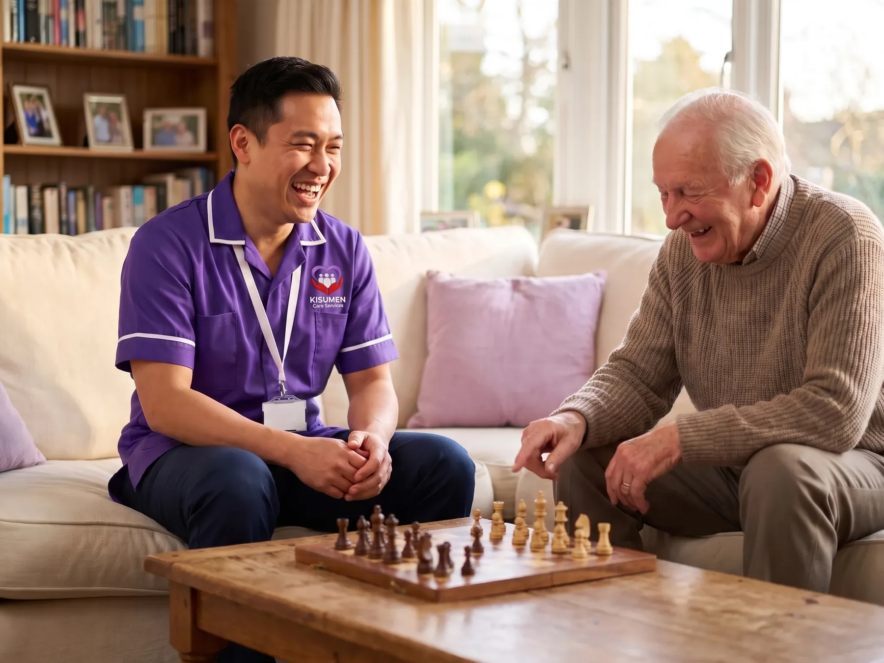 Regular Kisumen carer enjoying a game of chess with an older man during a home care visit