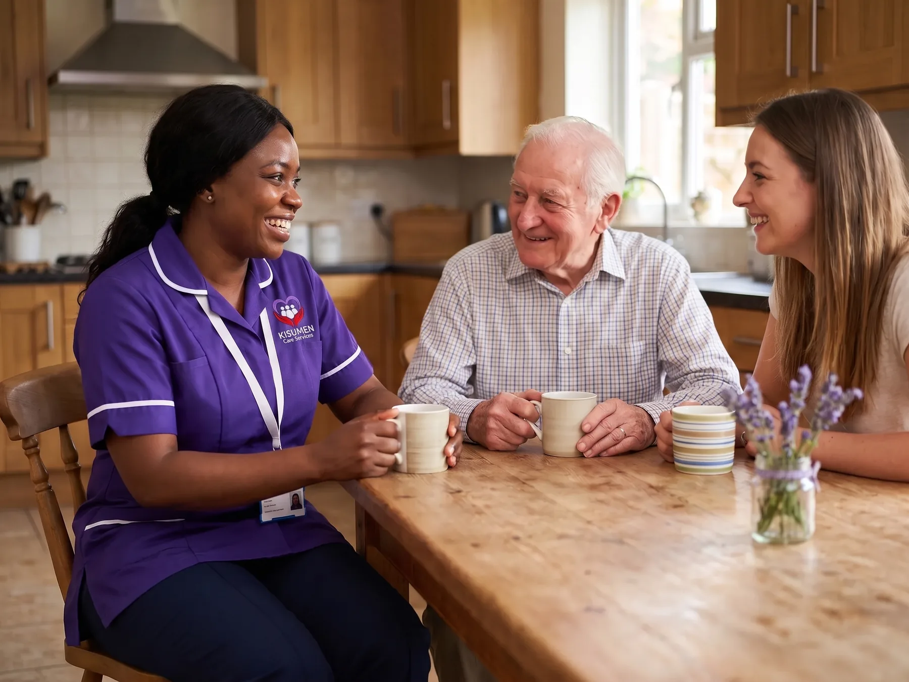Kisumen carer chatting informally with an older man and his granddaughter over tea